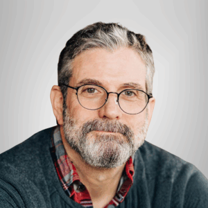 photo of a man with black and gray hair beard and mustache and glasses